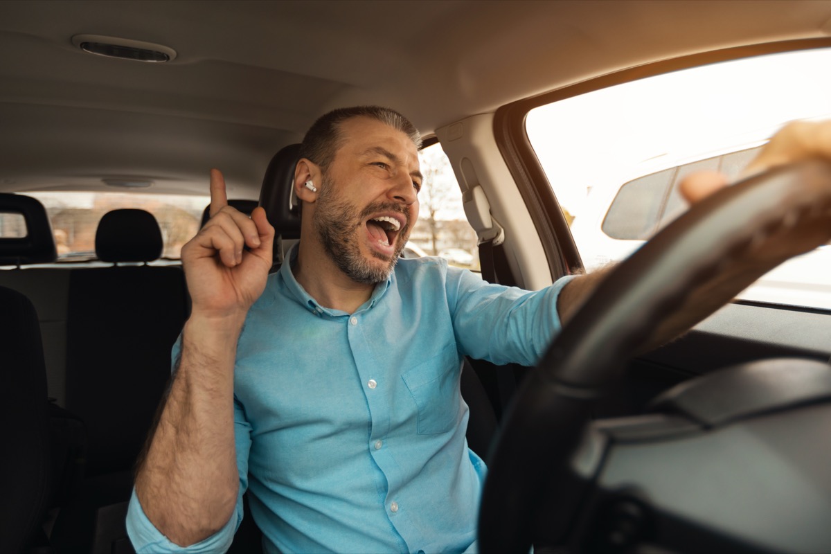 Happy man driving and listening to music